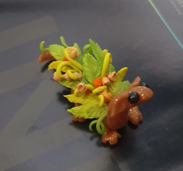 miniature dragon made from clay with flowers