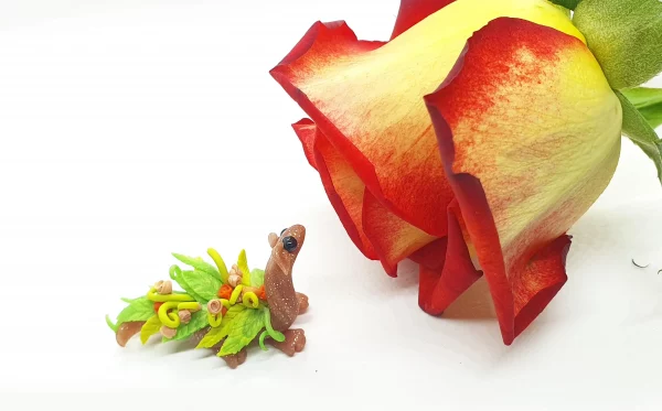miniature dragon made from clay with flowers