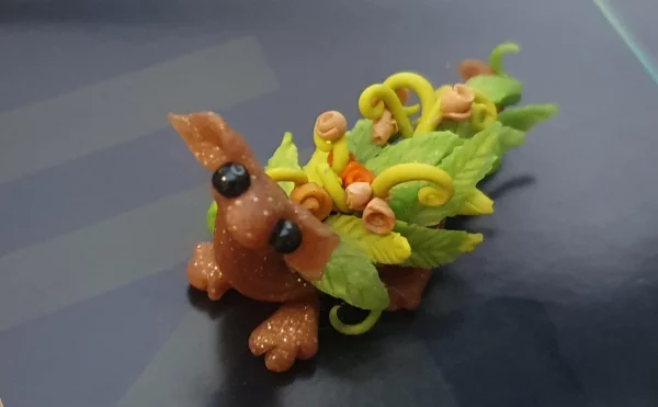 miniature dragon made from clay with flowers