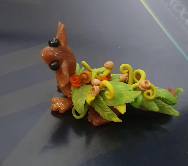 miniature dragon made from clay with flowers